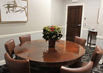 Eagle Room with TV and floral centerpiece on round table.