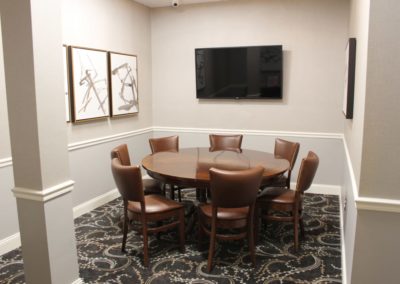 Eagle Room with TV and round table.