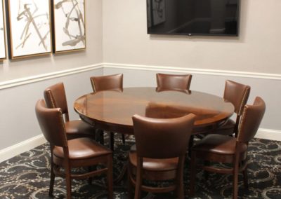 Eagle Room with TV and round table.