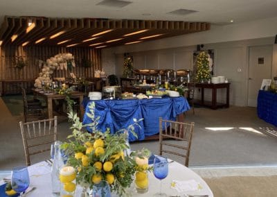 Private event room with round table in foreground with lemon centerpiece.